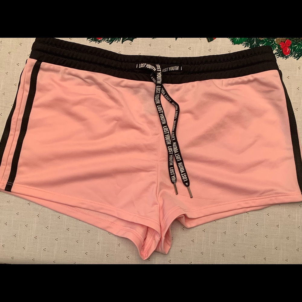 Forever 21 new with tags, short shorts. Pink with black accents. “Lost youth”